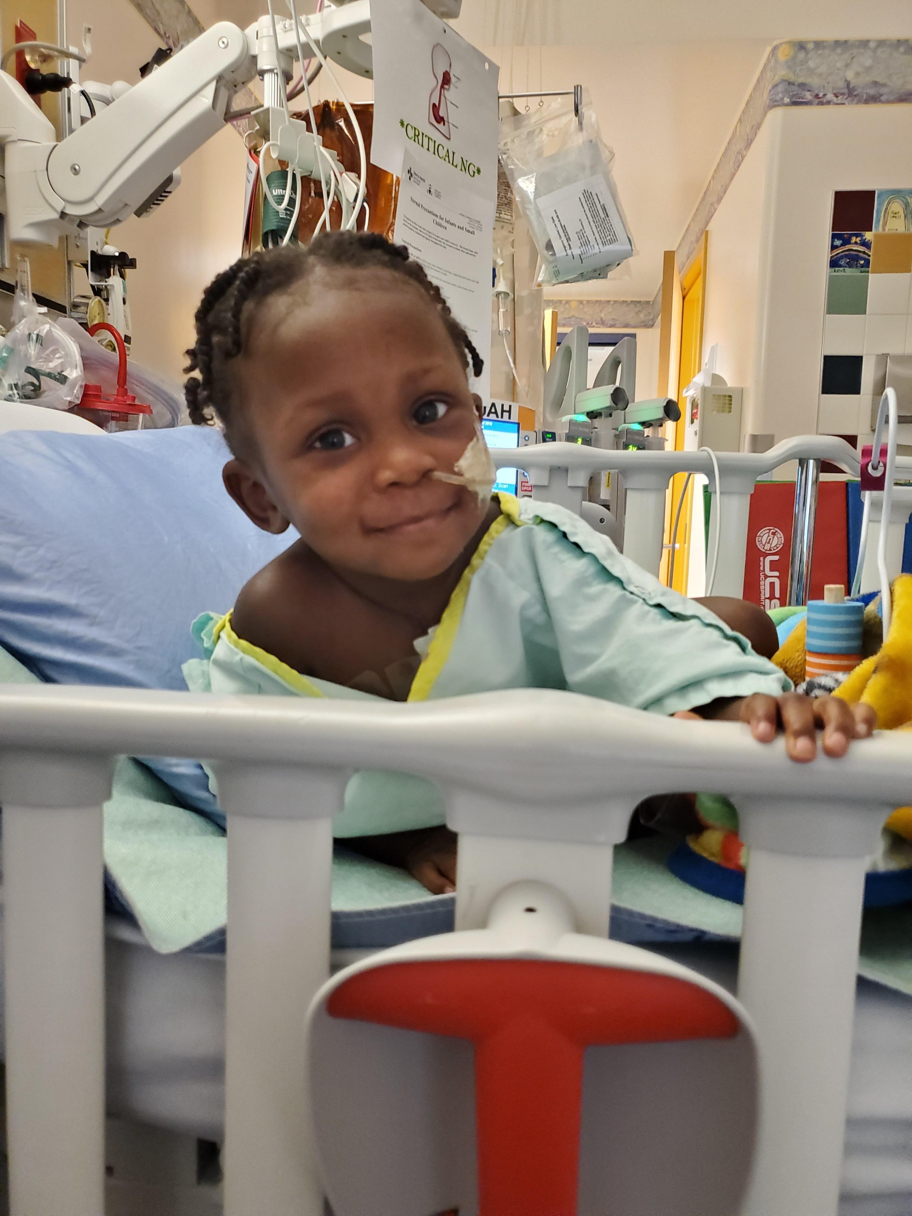 Amélie Adolphe smiles for the camera after moving from Pediatric Intensive Care Unit (PICU) to the In-Patient Unit. Her first smile since being hospitalized.