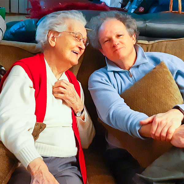 Image of Paul and his mum sitting on a couch