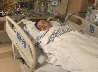 Brock sleeping in hospital bed