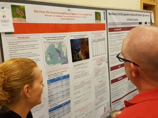 Dr. Fearon shows her poster to Dr. Semple Dr. Fearon shows her poster to Dr. Semple