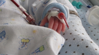 Image of a baby in the hospital bed performing a blood transfusion Image of a baby in the hospital bed performing a blood transfusion