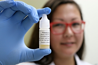 Tamiko Stewart, project lead at Canadian Blood Services' Centre for Innovation, holds a filled bottle of plasma eye drops.