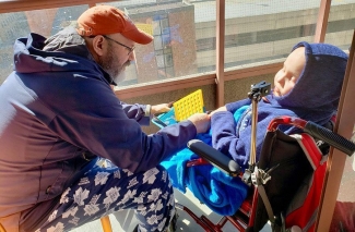 Mario and his son, Ollie, get some fresh air on the balcony of their condo in Toronto. The family is hoping Ollie can soon receive a transplant of stem cells from Ollie’s sister Abby.
