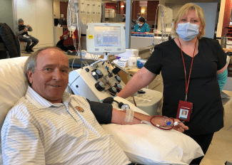 Richard giving blood and Nurse Roxanne