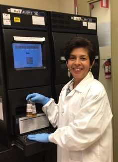 Dr. Ramirez in the lab with the BacT/ALERT bacterial screening system.