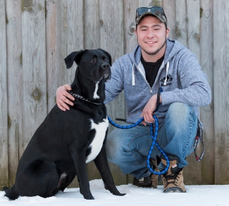 Scott-and-his-dog Scott Monds, who had two stem cell transplants from a single donor, crouches with his arm around his black and white dog, Beau