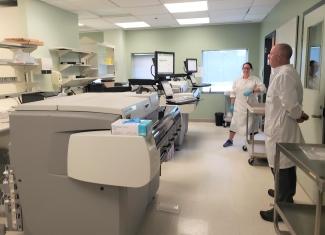 Our Centre for Innovation’s Craig Jenkins, senior manager, and Valerie Conrod, senior medical laboratory technologist, oversee the two instruments used for COVID-19 immunity assessment in blood donors.