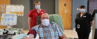 Percy Wilbur of Saint John, N.B., is the first to donate convalescent plasma in Atlantic Canada, with nurses Karla Campbell (right) and Jo-Elle Nordstrom (left) tending to him