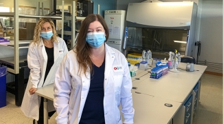 Dr. Olga Mykhailova (Left) and Tracey Turner (Right) standing in the lab where they helped label more than 52,000 red blood cell images.