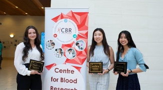 Summer students who won awards holding their award plaques