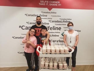Emad Elshmoury and his family deliver 45 milkshakes for Edmonton collections manager Kerry Parsons to share with staff