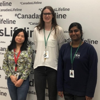 The three authors of this blog post stand in a donor centre in Calgary
