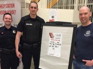 Jamie Maillet standing with Saint John Police Force organizing the first ever Sirens For Life blood drive.
