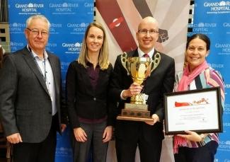 The Grand River Hospital holding up a trophy and a certificate winning the Ontario Hospital Challenge
