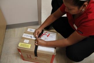 Image of a Canadian Blood Services Employee packing up a box for OneMatch