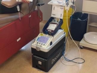 Nothing unusual is going on here: You’ll find all the same bags, tubes and monitoring equipment used in a regular donation clinic.  [Blood donation in progress, with blood flowing through the tube from patient to blood bag.]