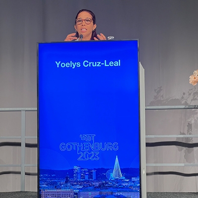 Yoelys Cruz behind a blue podium