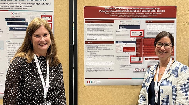 Dr. Kathryn Webert and Dr. Michelle Zellers standing in front of a poster