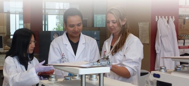 Group of lab researchers grouping up together and discussing