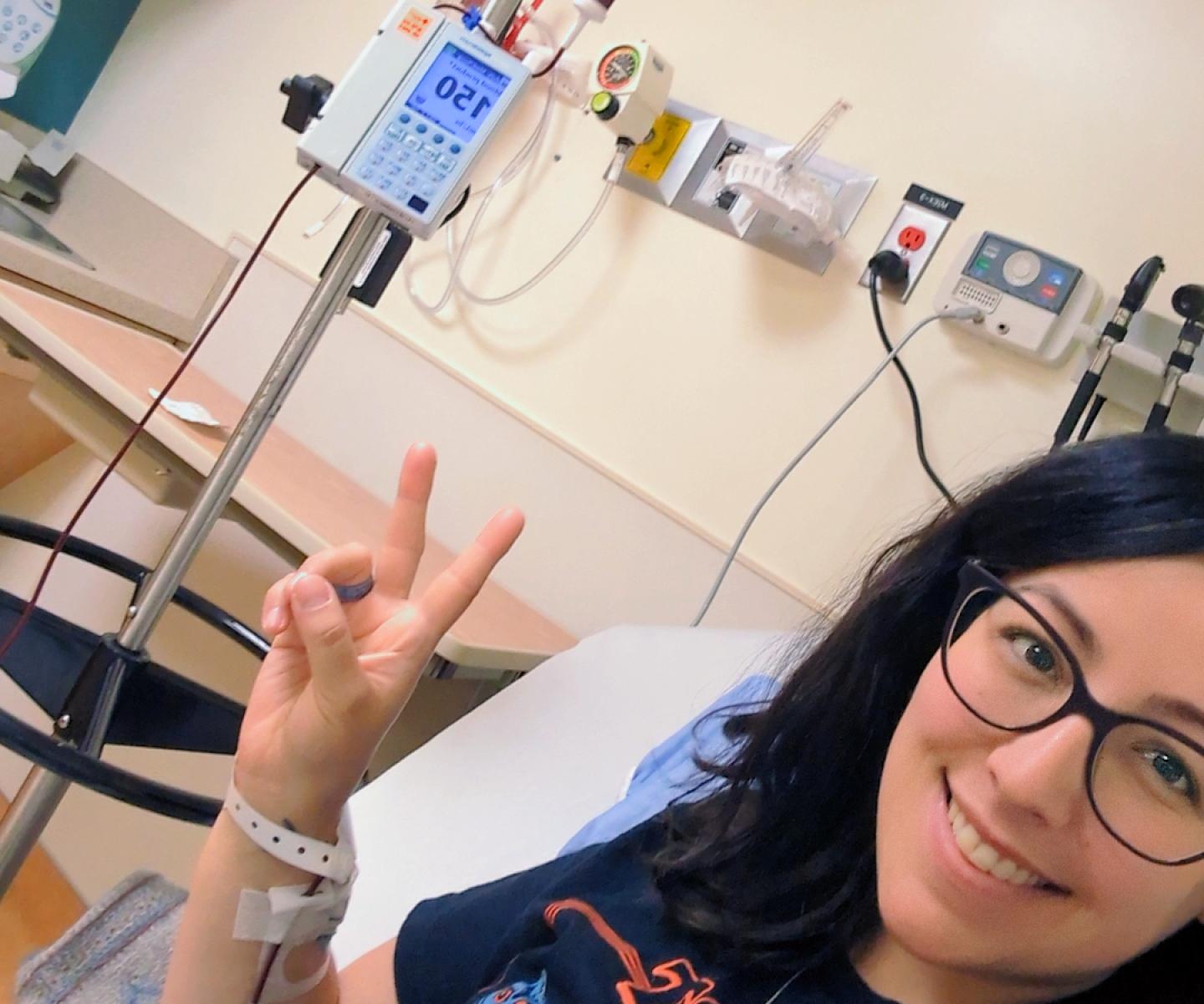 blood recipient giving peace sign while receiving blood