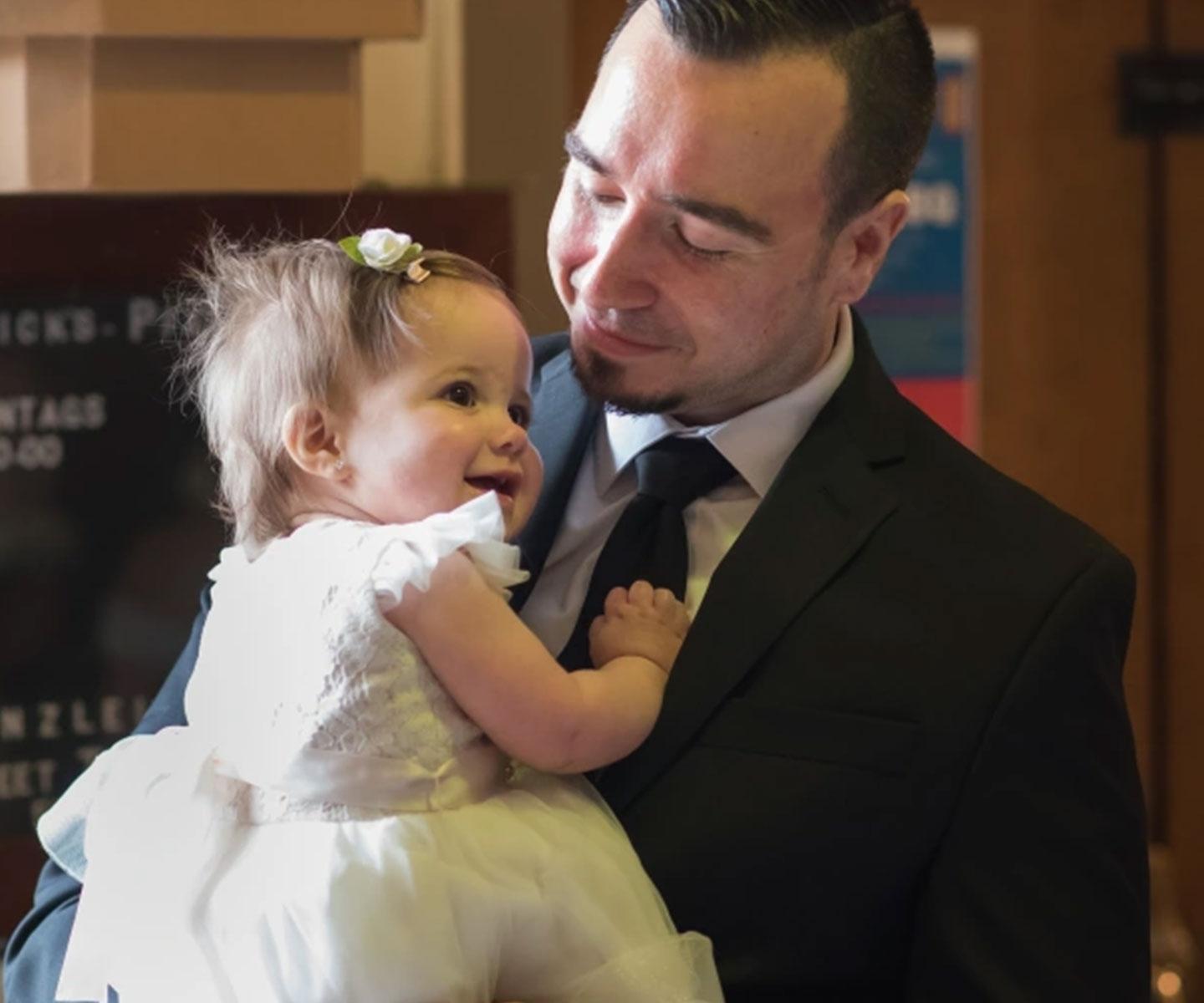 Blood and stem cell recipient Adam Coletta holding his daughter
