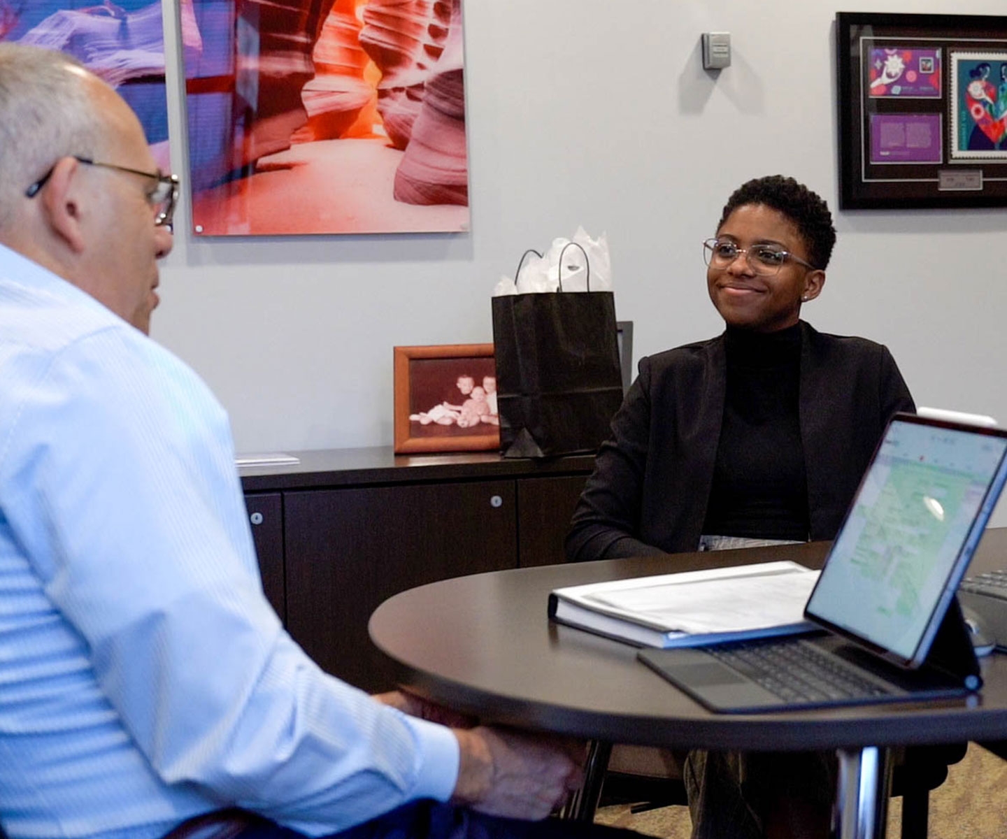 Young woman and CEO mentor facing each other in office