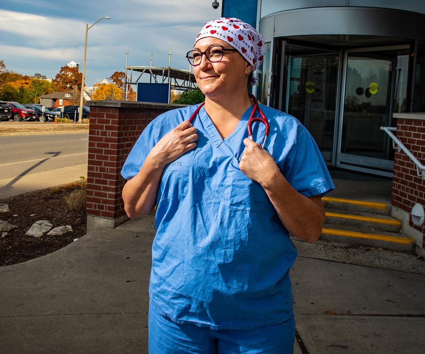 Emergency room nurse in scrubs outside a hospital