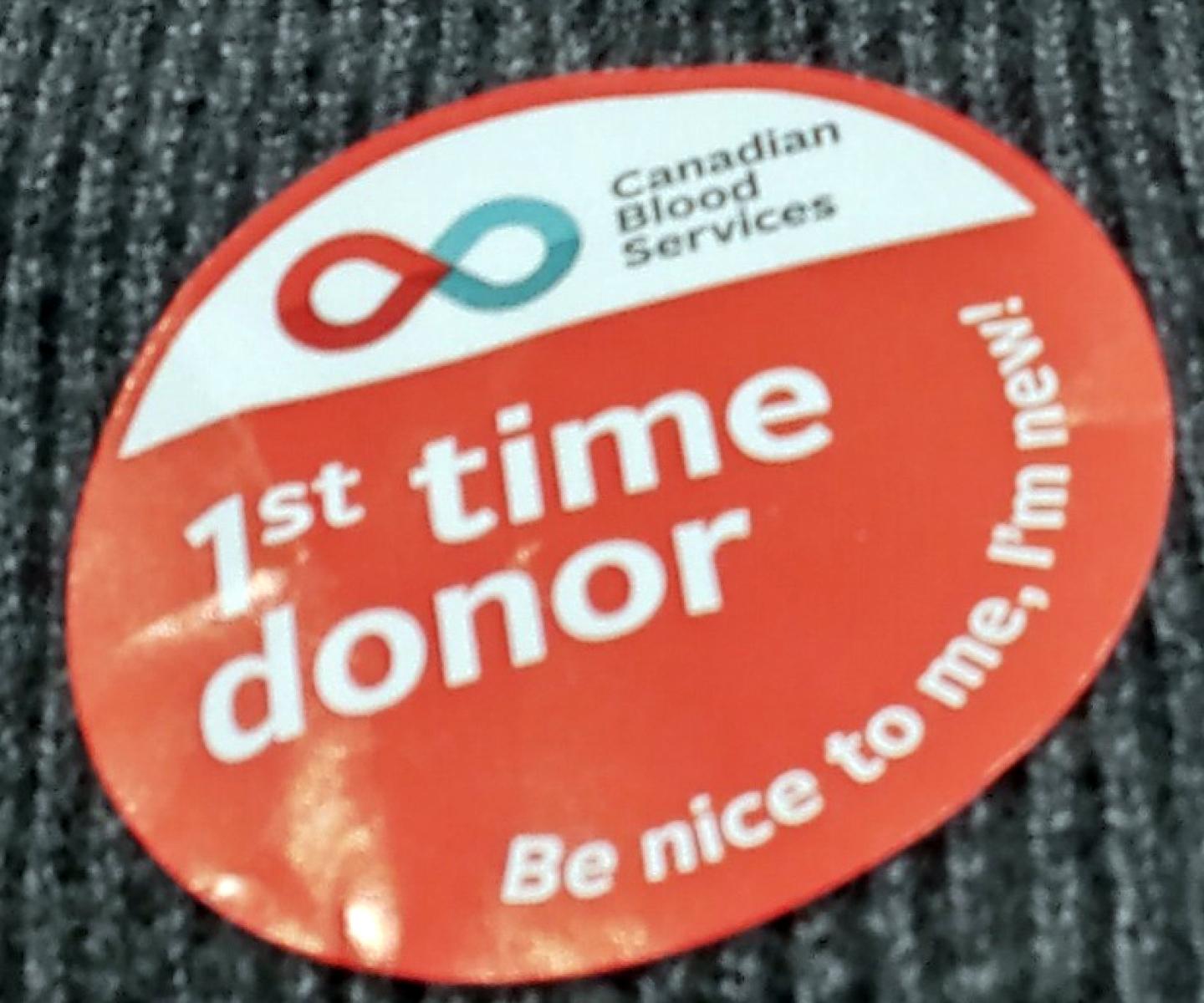 Canadian Blood Services First time donor sticker on brown sweater
