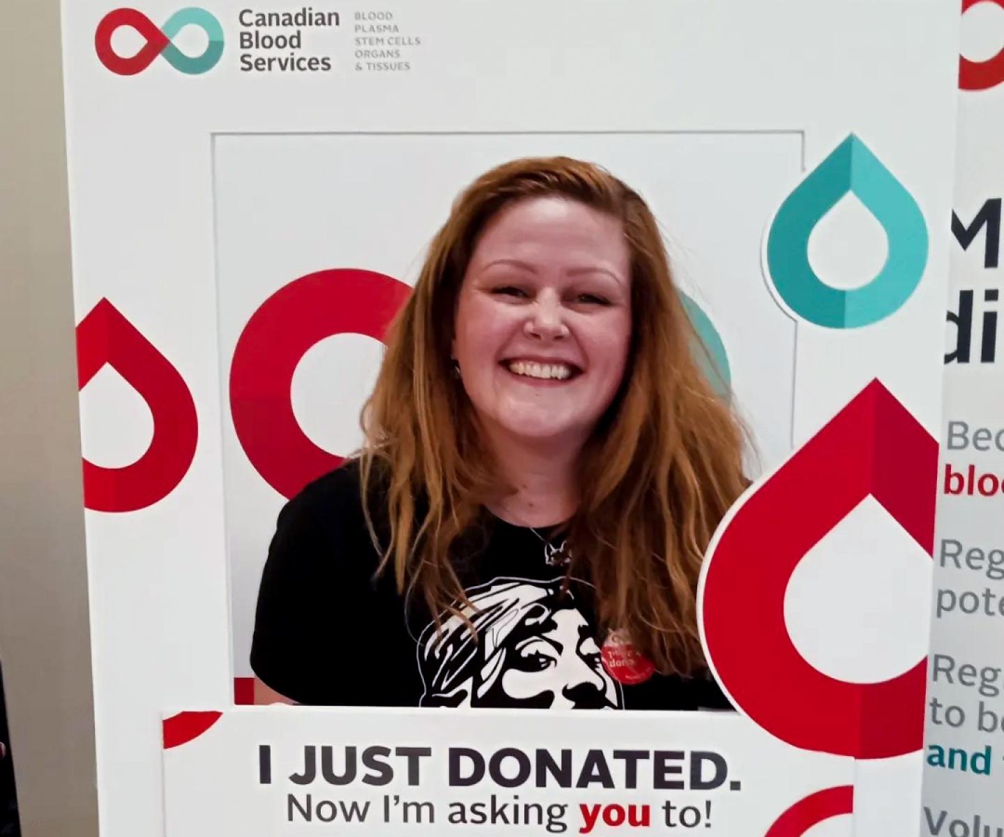 Blood donor with Canadian Blood Services sign