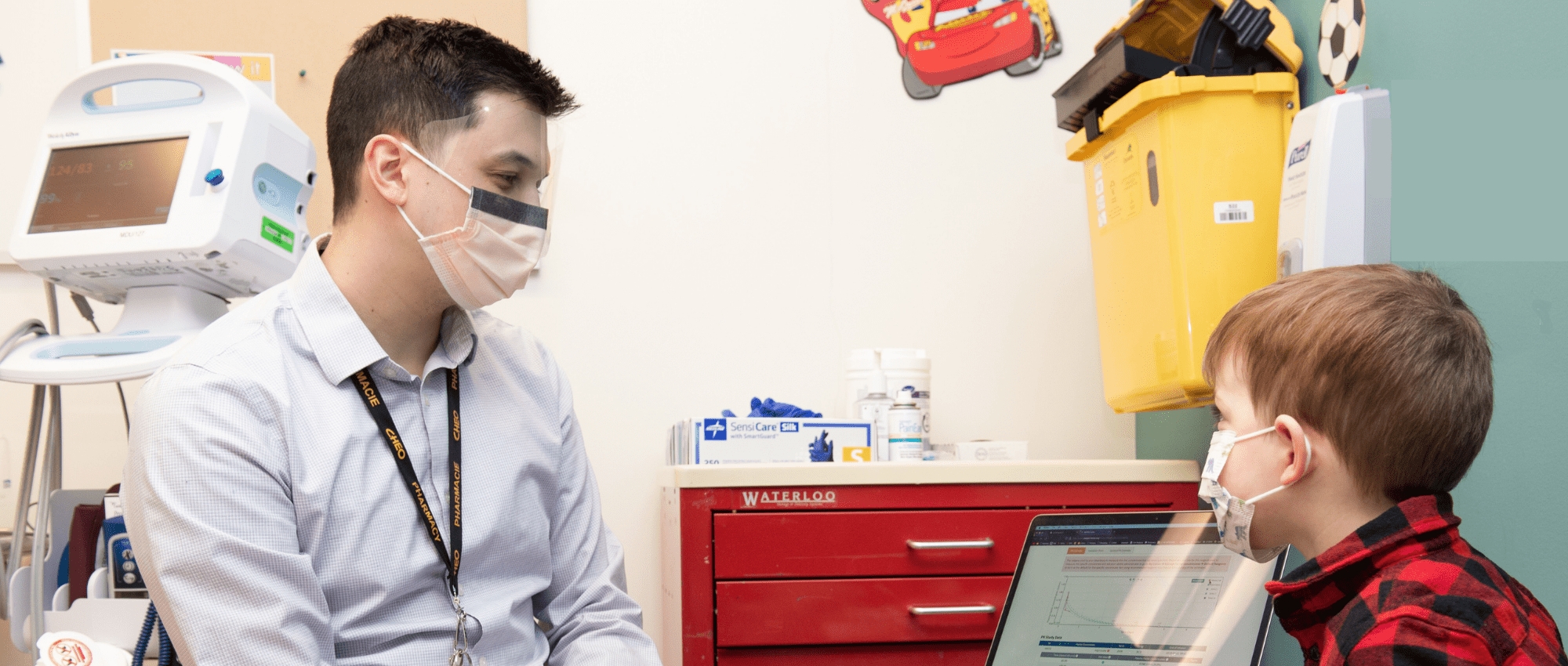 A pharmacist speaks with child patient with hemophilia at CHEO clinic