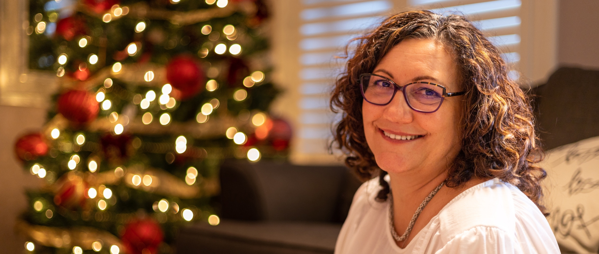 O-negative blood donor Julia Moore sits by a Christmas tree