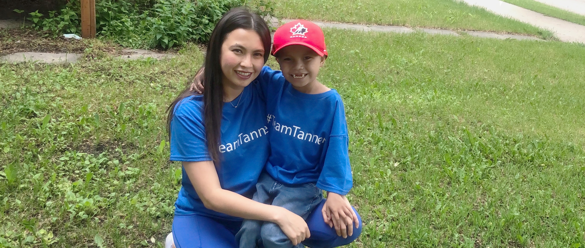 Miranda McLeod and her son Tanner smile together on their lawn.