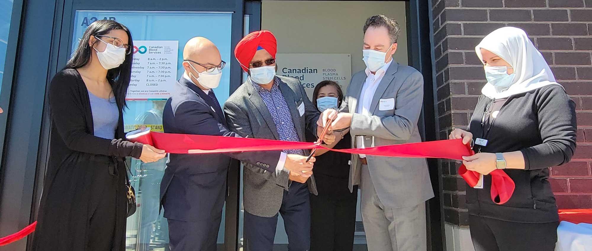 Canadian Blood Services ribbon-cutting with donor at new plasma donor centre in Brampton, Ont.