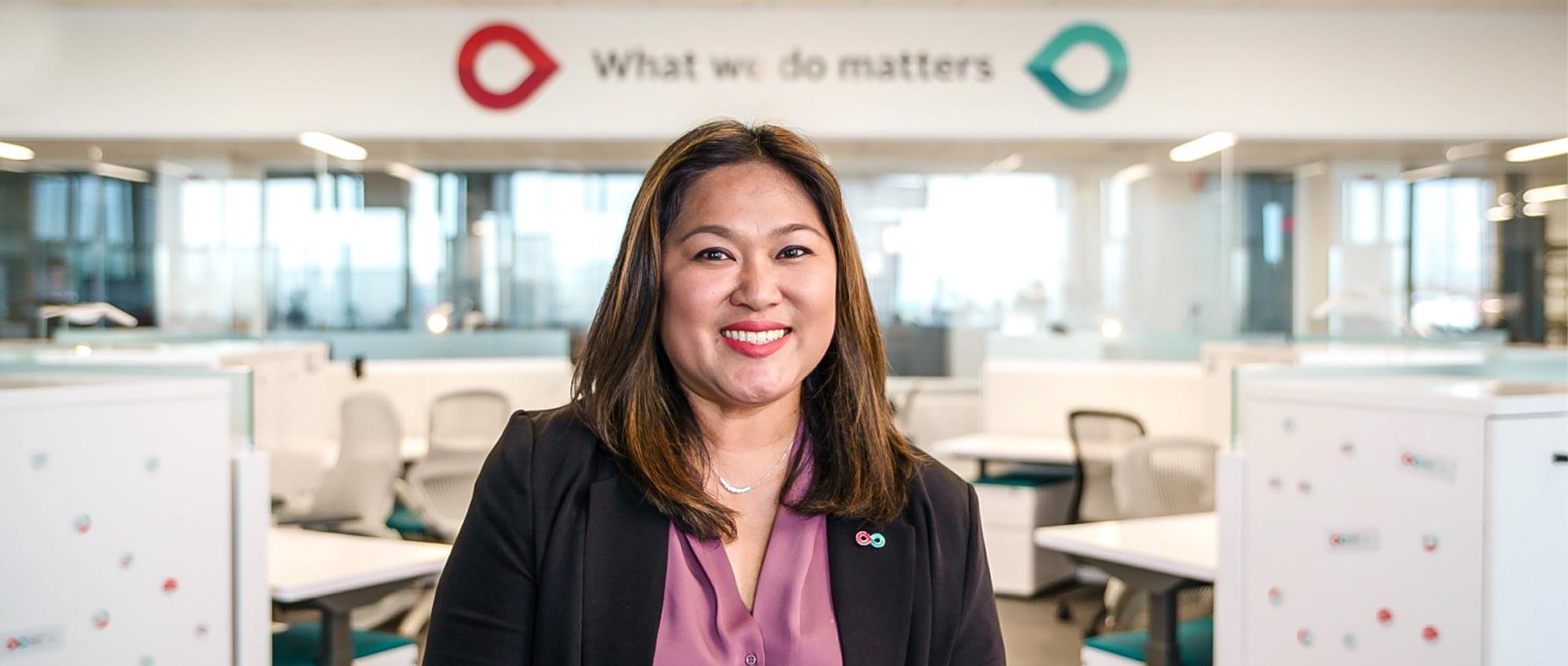 Thumbnail image of close up Territory manager for Calgary, Alberta, Jhoanna Del Rosario sitting in the Workplace of the Future at the new Canadian Blood Service Operational Facility