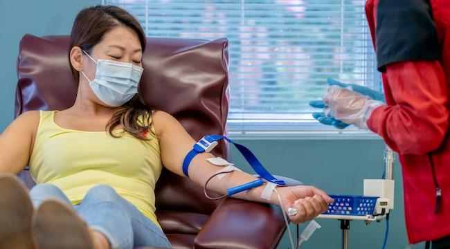 Woman's arm donating blood