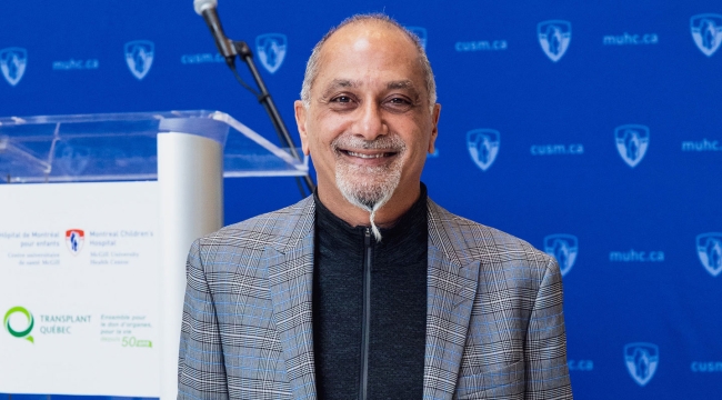 Dr. Sam Shemie posing for camera holding the Grand Prix award. 