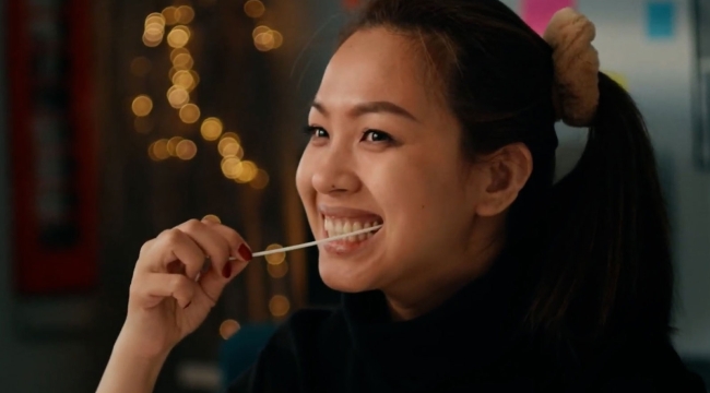 Young woman putting a swab in mouth