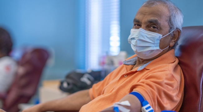 Blood donor in donation chair with arm extended