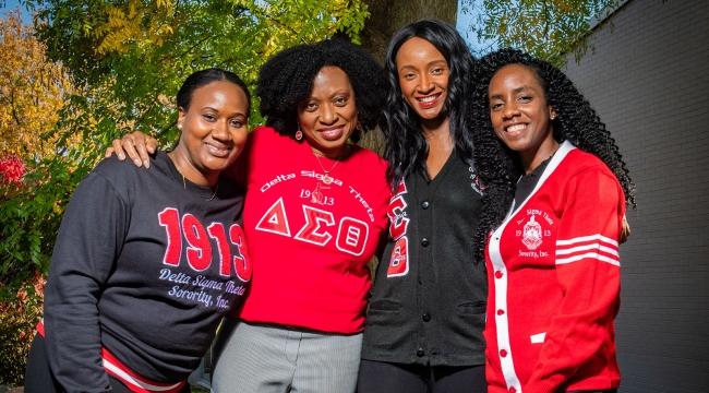 Four members of the Toronto chapter of Delta Sigma Theta Sorority, Inc., together outdoors in sorority clothing