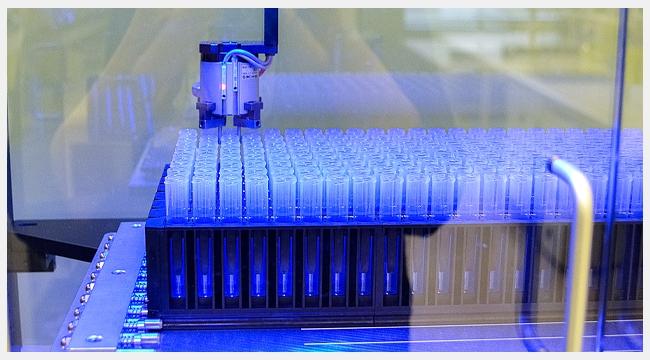 Thumbnail image of test tubes in a containment unit in a blue light testing samples.