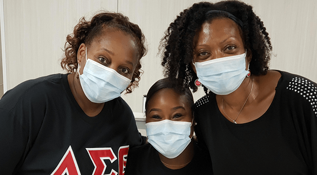 Three blood and stem cell advocates smile together after donating blood 