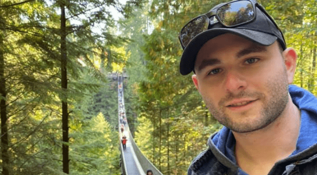 Blood recipient, Ben Becker, on suspension bridge in forest 