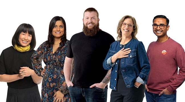 Five people connected to Canada’s Lifeline, stand and smile looking toward the camera. 