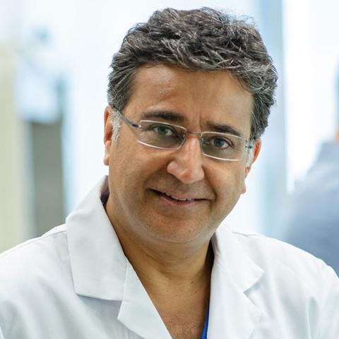 Dr. Shaf Keshavjee wearing a lab coat