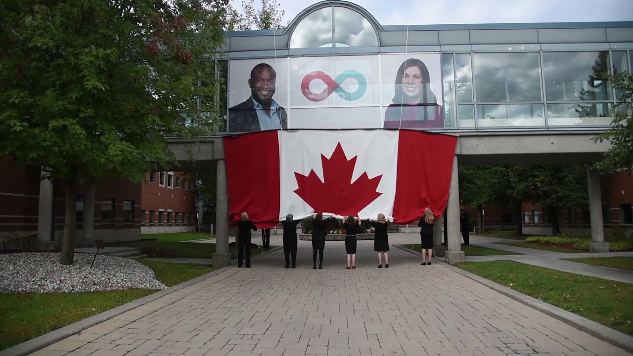 YouTube video thumbnail of people pulling down a large Canadian flag outside the Canadian Blood Services head office to unveil the brand renewal